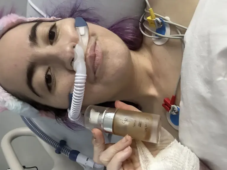 Miriam in the ICU during her hospital stay. Intubated but looking divine, doing her skincare routine.